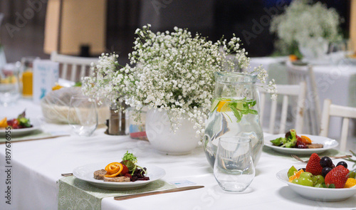 Close-Up of Elegant Banquet Table with Baby's Breath Centerpiece and Fresh Fruit Appetizers