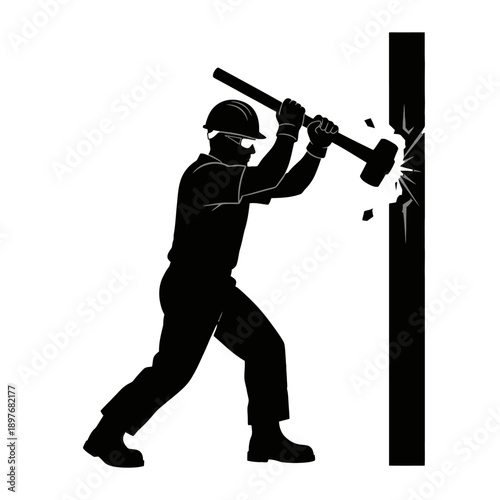 Construction worker breaking wall with sledgehammer.