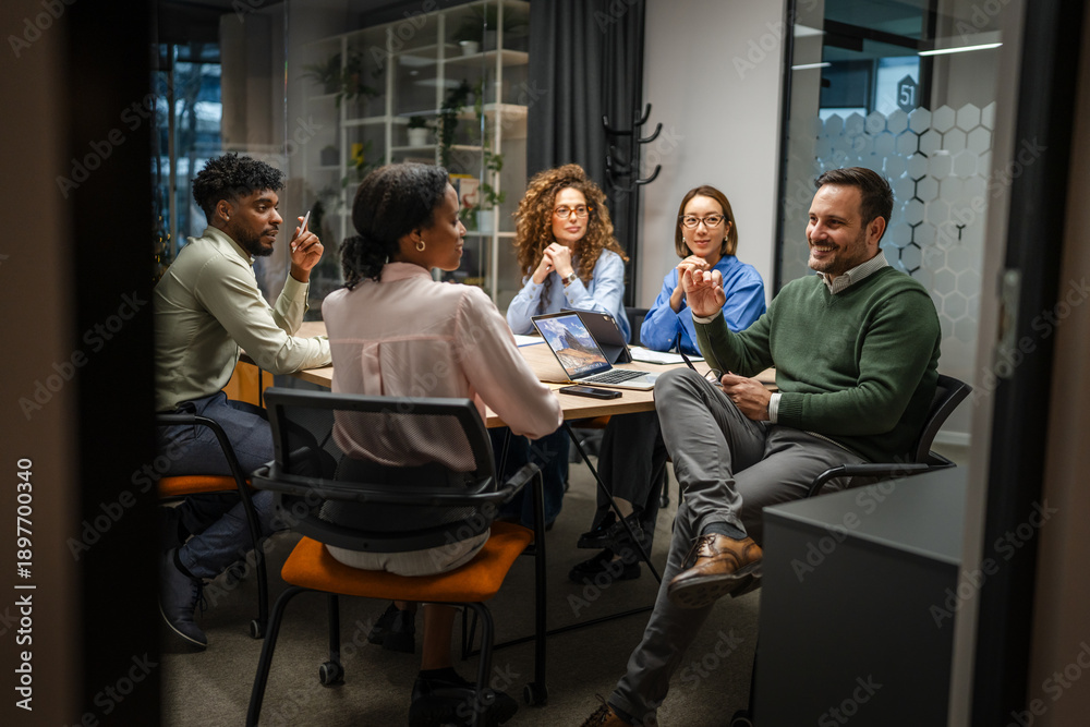 Fototapeta premium Diverse business team collaborating in a modern office meeting