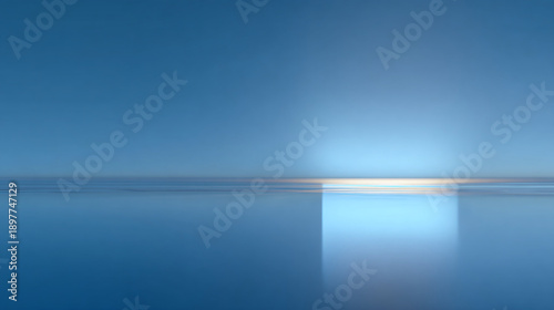 A serene view of the sea under a clear sky. The horizon meets at the water, and the sun is reflecting in the ocean