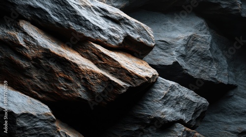 Textured Close-Up of Natural Stones with Varied Surfaces and Lighting in Dark Surroundings Highlighting Geological Features and Patterns