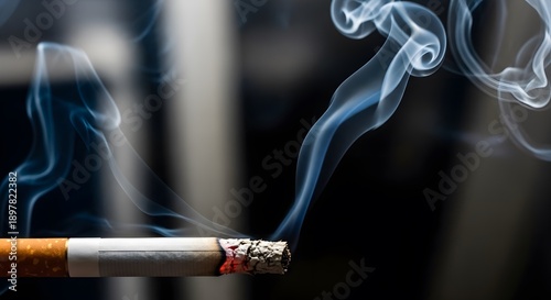 A cigarette with smoke rising against a dark background