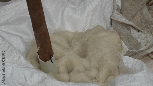 Authentic preparation of white sticky rice using traditional pounding methods for cultural food heritage and local craft.