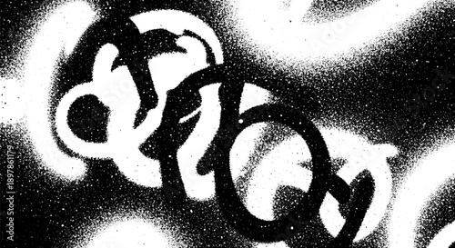 Abstract black and white spray paint texture with organic shapes.