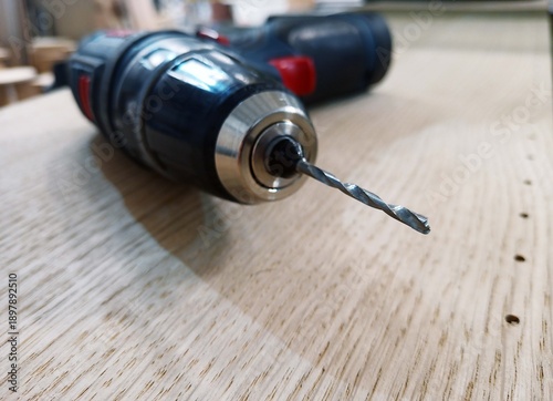 drilling holes with a hand drill and a thin drill bit. close-up. technological process. illustration.