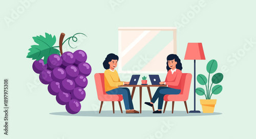 Two women sit at a table with laptops, near grapes and a plant