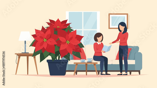 Two women in red tops interact by a sofa, one reading, with poinsettias