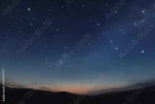 Deep blue night sky filled with bright stars over dark mountains at twilight