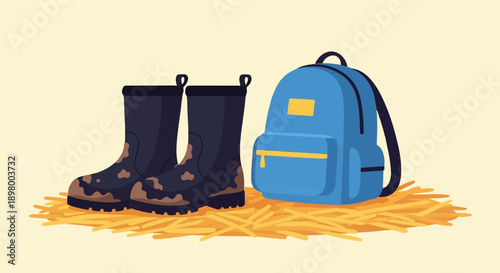 Muddy boots and blue backpack resting on straw