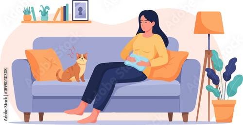 Person with heating pad on stomach sitting on couch with cat and lamp