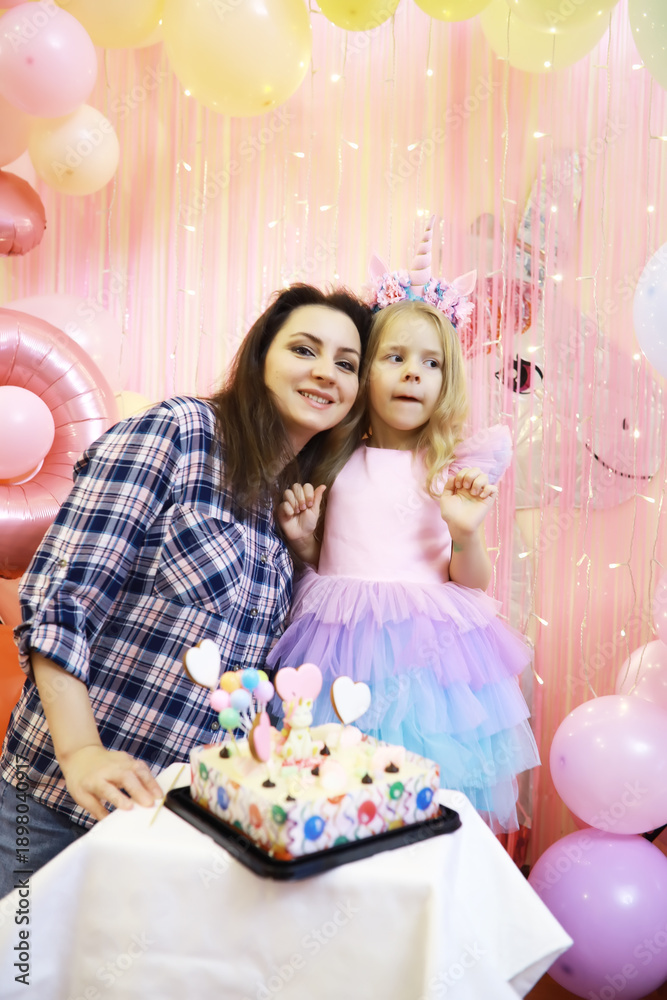 Fototapeta premium Mother and Daughter Celebrating Birthday with Unicorn Theme Party Decorations