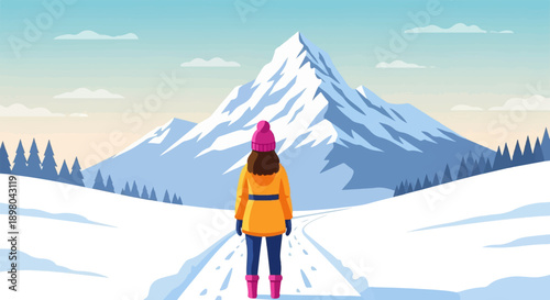 Person stands on snowy path facing majestic snow-capped mountain