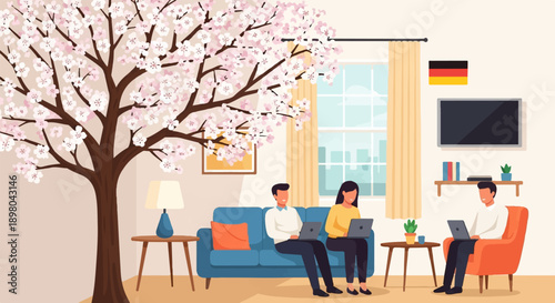 People working on laptops in a living room with a cherry blossom tree