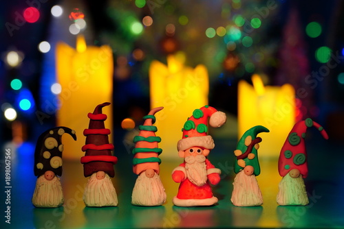 Wallpaper Mural Figures of gnomes and Santa made of plasticine on the background of Christmas candles. Torontodigital.ca