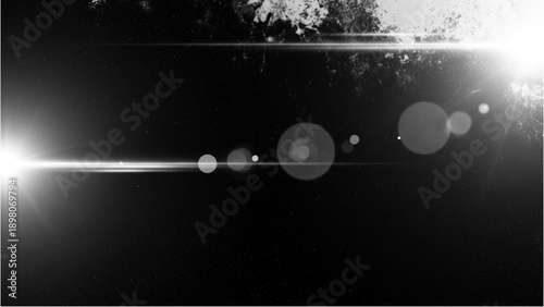 A bright light shines through trees, casting lens flares on a dark landscape from a low viewpoint