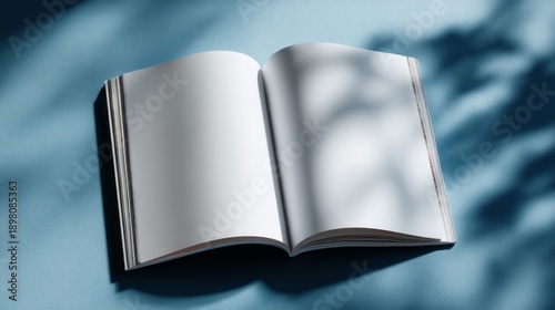 Wallpaper Mural A double-page spread of an open magazine lays on a calm blue surface, surrounded by soft shadows that invite creativity and imagination. Perfect for planning or brainstorming ideas Torontodigital.ca