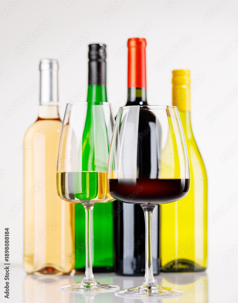 Obraz premium Different wine bottles and glasses on white background