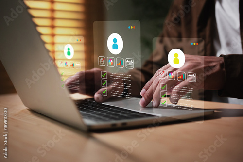 Foto Man is working on a laptop,  displaying customer profiles or human resources (HR