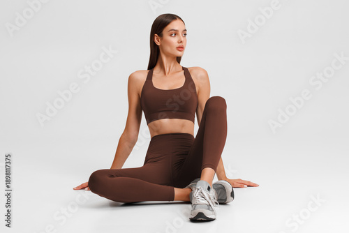 Athletic girl on the gray background. Fitness woman