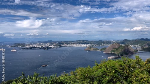 Wallpaper Mural Wide panoramic shot from Pão de Açúcar overlooking the city of Niterói. Captures the deep blue waters of Guanabara Bay, the Niterói coastline, and distant mountains under a clear tropical sky Torontodigital.ca