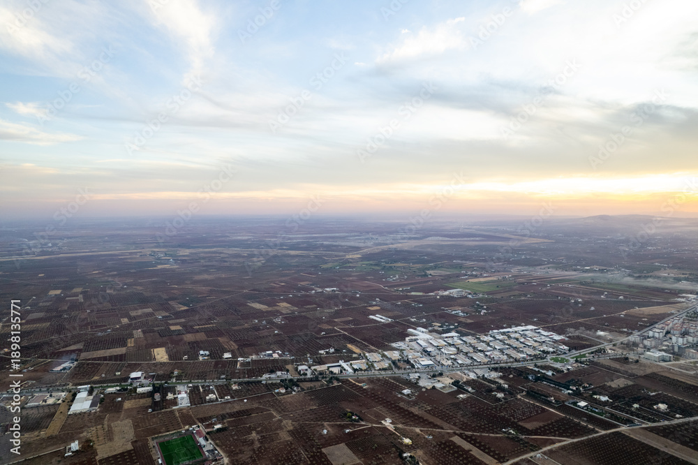 Obraz premium Aerial Panorama of Kilis Small Industrial Site and City Center Nestled Amongst Vast Agricultural Lands and Olive Groves