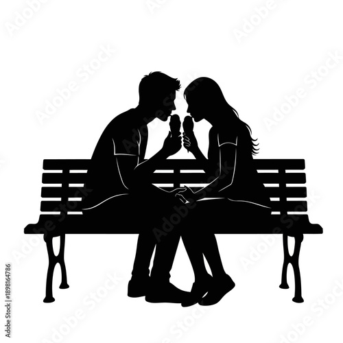 A romantic couple sitting on a bench together at night