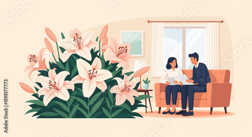 Two people discuss documents while sitting on a couch next to a large bouquet of lilies