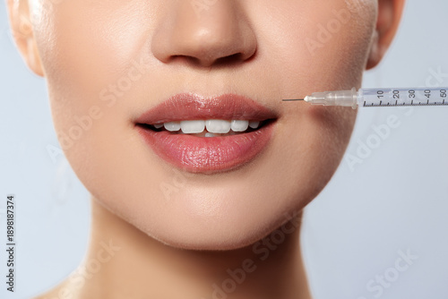Tableau sur toile Woman receiving injection for lip enhancement in cosmetic clinic during daytime