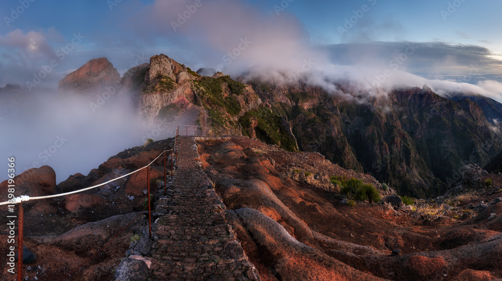 Fototapeta premium Landscape of sunrise in mountain over clouds in Madeira Island on Pico do Arieiro over steep cliffs and mountains in central Madeira. Portugal