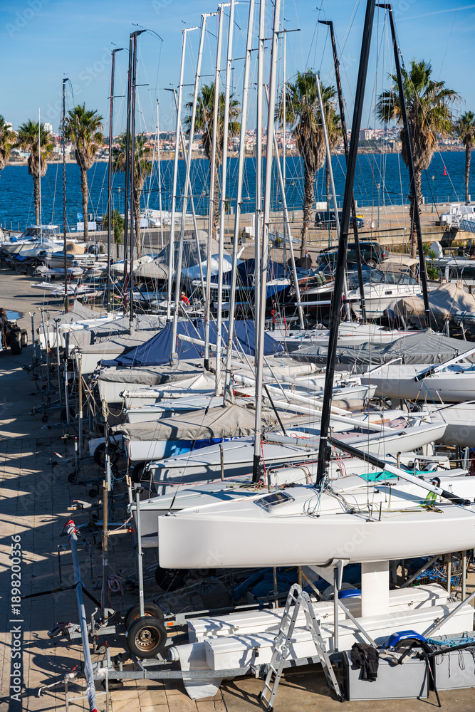 Fototapeta premium Yachts in a marina against the background of the city and other ships, in Cascais, Portugal