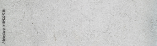 Close up photo of an aged white wall suitable for background textures or architectural design concepts in photography or graphic design projects.