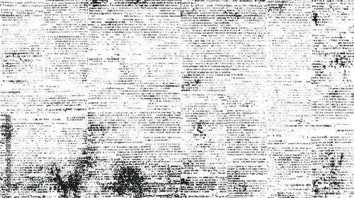 Black and white distressed textured background of dense newspaper print with scattered ink splatters and smudges