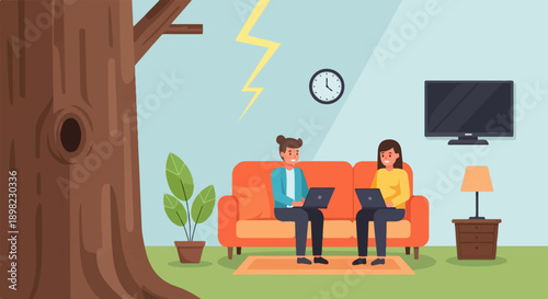 Two people work on laptops on a couch in a room with a tree outside