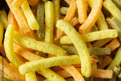 A top down view of a pile of veggie straw chips, as a background.