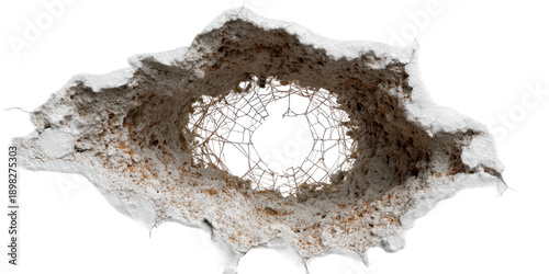 A close-up view of a bullet hole with torn edges against a black background