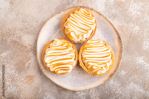 Obraz na płótnie French lemon tart with meringue on brown concrete, top view, flat lay, close up