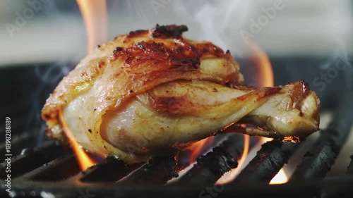 Grilled Chicken on Fire B Q Grill Closeup Sizzling Meat