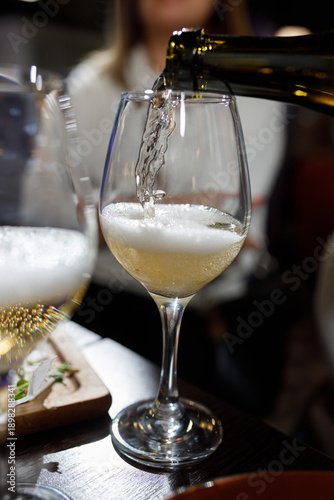 Pouring champagne into a glass at a celebration