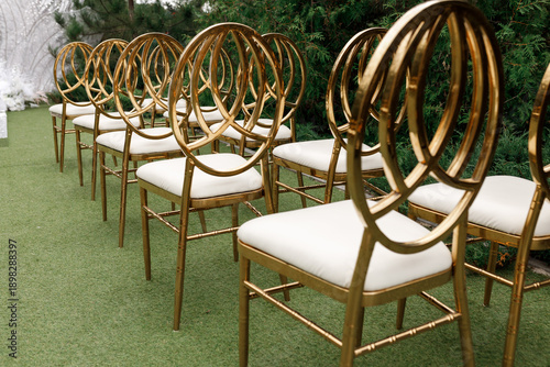 Rows of Elegant Golden Chairs at Outdoor Wedding Ceremony