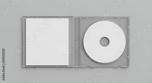blank dvd case, Open clear plastic CD jewel case with blank white disc and insert for branding. Mock-up of compact disc packaging on soft gray background. Represents digital storage, music or software