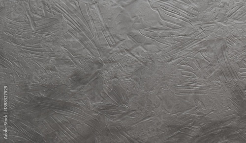 Foto This abstract image displays a cool grey, highly textured surface with myriad ra