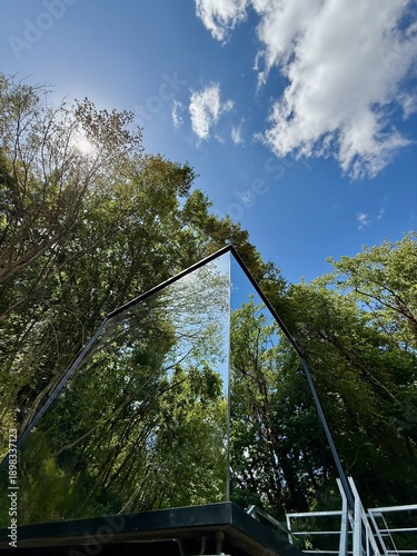 Mirrored Glass Cabin Reflecting Forest in Tuscany