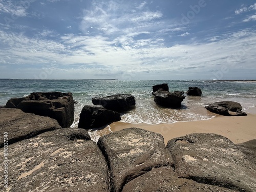 Rocky Beach with Waves and Blue Sky