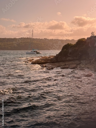 Rocky Coastline at Sunset with Boat on the Water