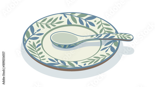 A decorative ceramic plate with a matching spoon featuring a blue and green leaf pattern on a white background.