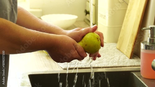 Woman cuts apples and pears for pie
