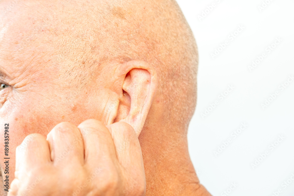 Fototapeta premium man touches ear canal, suggesting discomfort from earwax buildup or hearing issues, Signs of blocked ears, ossibly experiencing hearing loss or pressure, health concern, self-care procedure