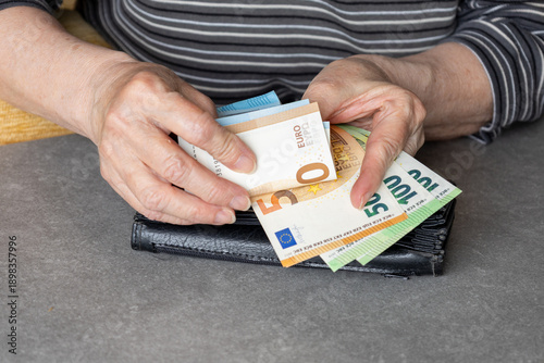 senior hands holding euro banknotes wallet

