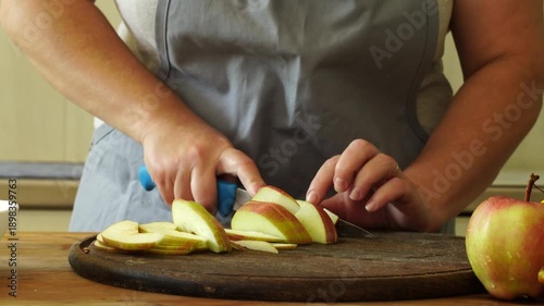 Woman cuts apples and pears for pie
