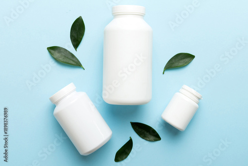 Wallpaper Mural supplement pills with medicine bottle health care and medical top view. Vitamin tablets. Top view mockup bottle for pills and vitamins with green leaves, natural organic bio supplement, copy space Torontodigital.ca